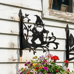 Garden gnome metal hanging basket bracket mounted on outdoor wall for plant decoration