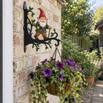 Garden gnome metal hanging basket bracket mounted on outdoor wall for plant decoration