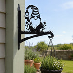 Garden gnome metal hanging basket bracket mounted on outdoor wall for plant decoration