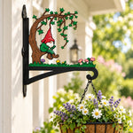 Garden gnome under tree metal hanging basket bracket mounted on outdoor wall for plant decoration