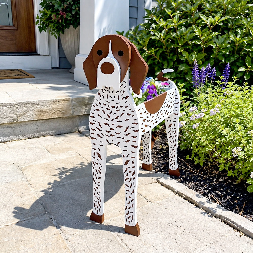 German Shorthaired Pointer dog planter filled with fresh flowers is placed in the garden.