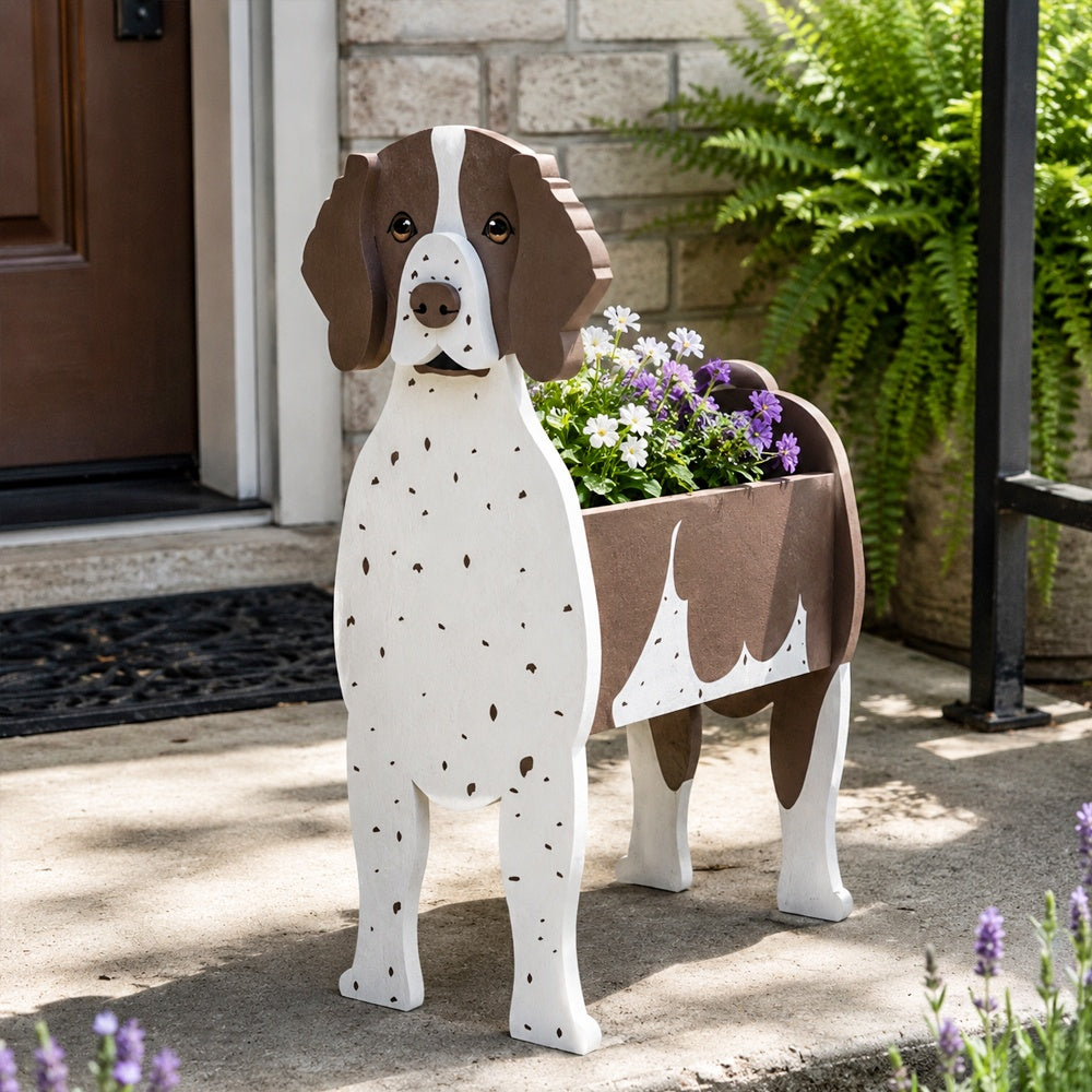 German Shorthaired Pointer dog planter filled with fresh flowers is placed in the garden.