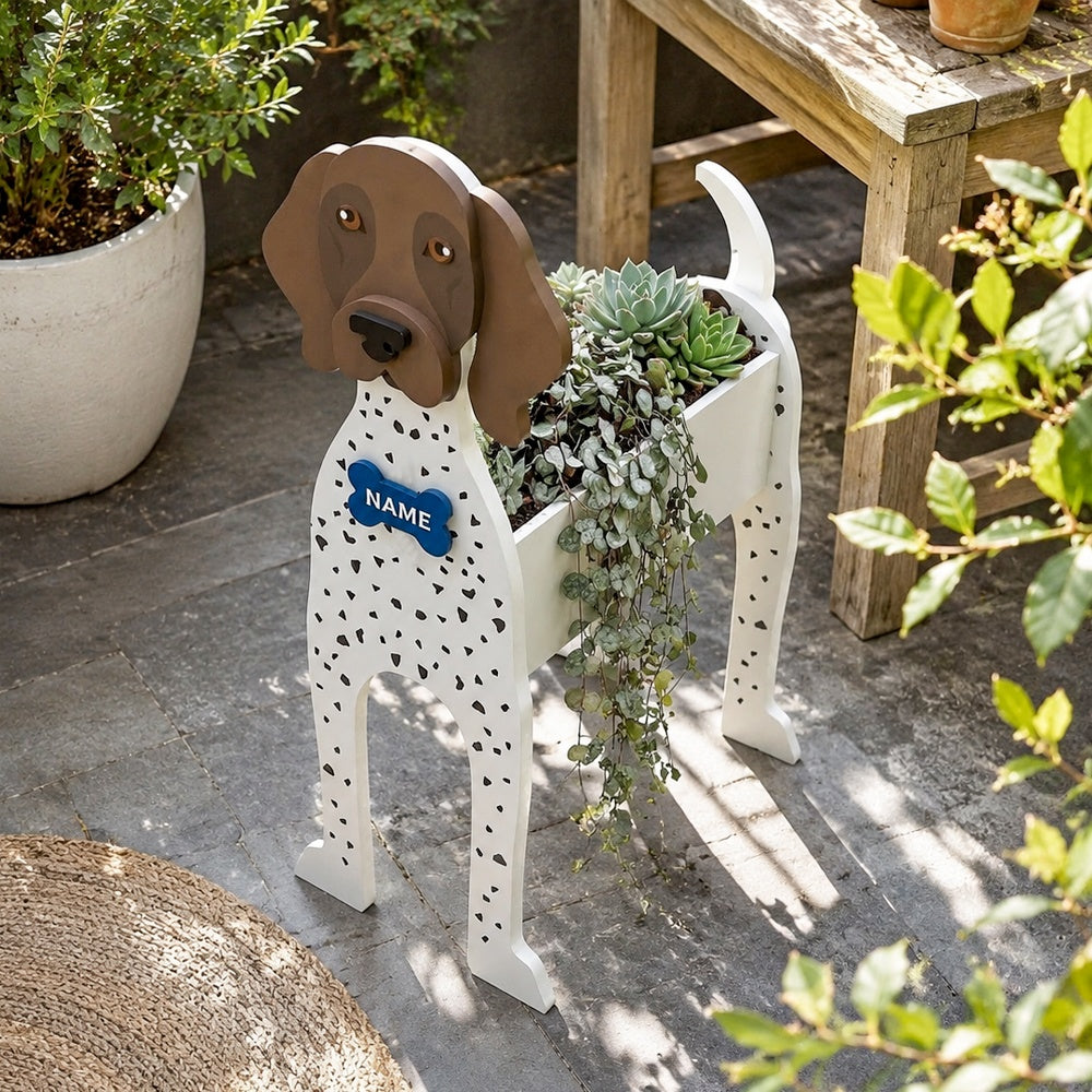 German Shorthaired Pointer dog planter filled with fresh flowers is placed in the garden.