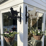 Golden retriever metal hanging basket bracket mounted on outdoor wall for plant decoration