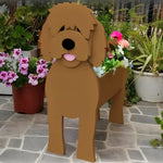 Goldendoodle dog planter filled with fresh flowers is placed in the garden