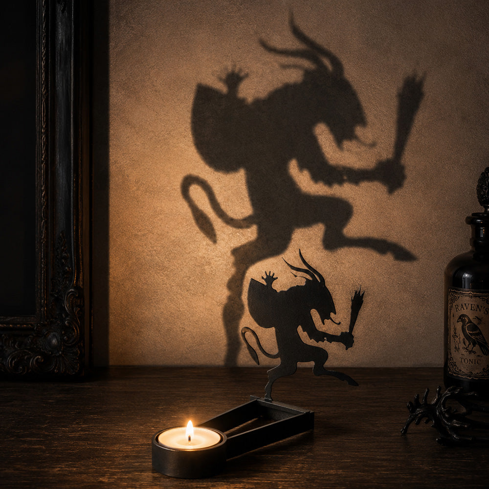 Graveyard creature halloween metal candle holder casting a spooky shadow on the wall