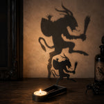 Graveyard creature halloween metal candle holder casting a spooky shadow on the wall