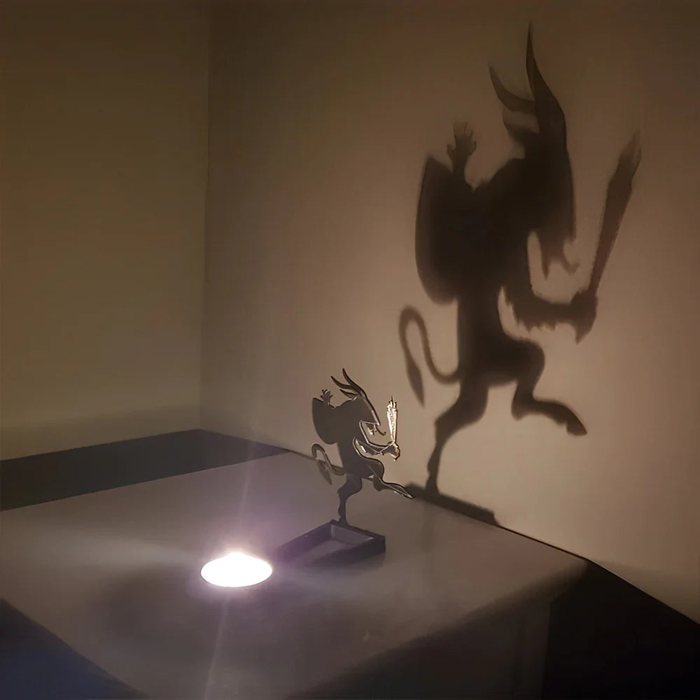 Graveyard creature halloween metal candle holder casting a spooky shadow on the wall