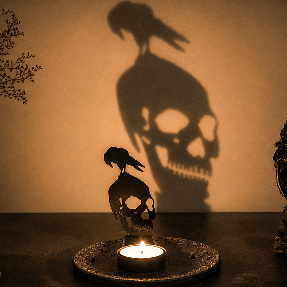 Graveyard skull halloween metal candle holder casting a spooky shadow on the wall