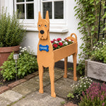 Great Dane dog planter filled with fresh flowers is placed in the garden.