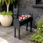 Great Dane dog planter filled with fresh flowers is placed in the garden.