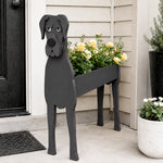 Great Dane dog planter filled with fresh flowers is placed in the garden.