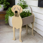 Great Dane dog planter filled with fresh flowers is placed in the garden.