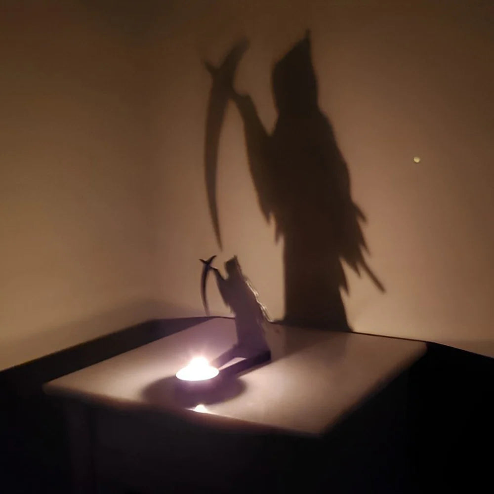 Grim reaper halloween metal candle holder casting a spooky shadow on the wall
