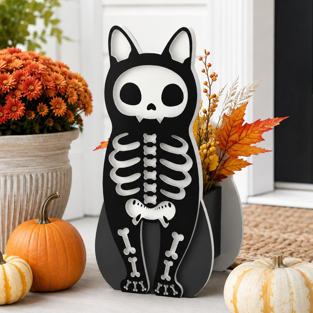 Halloween Skull Cat Planter filled with fresh flowers is placed in the garden