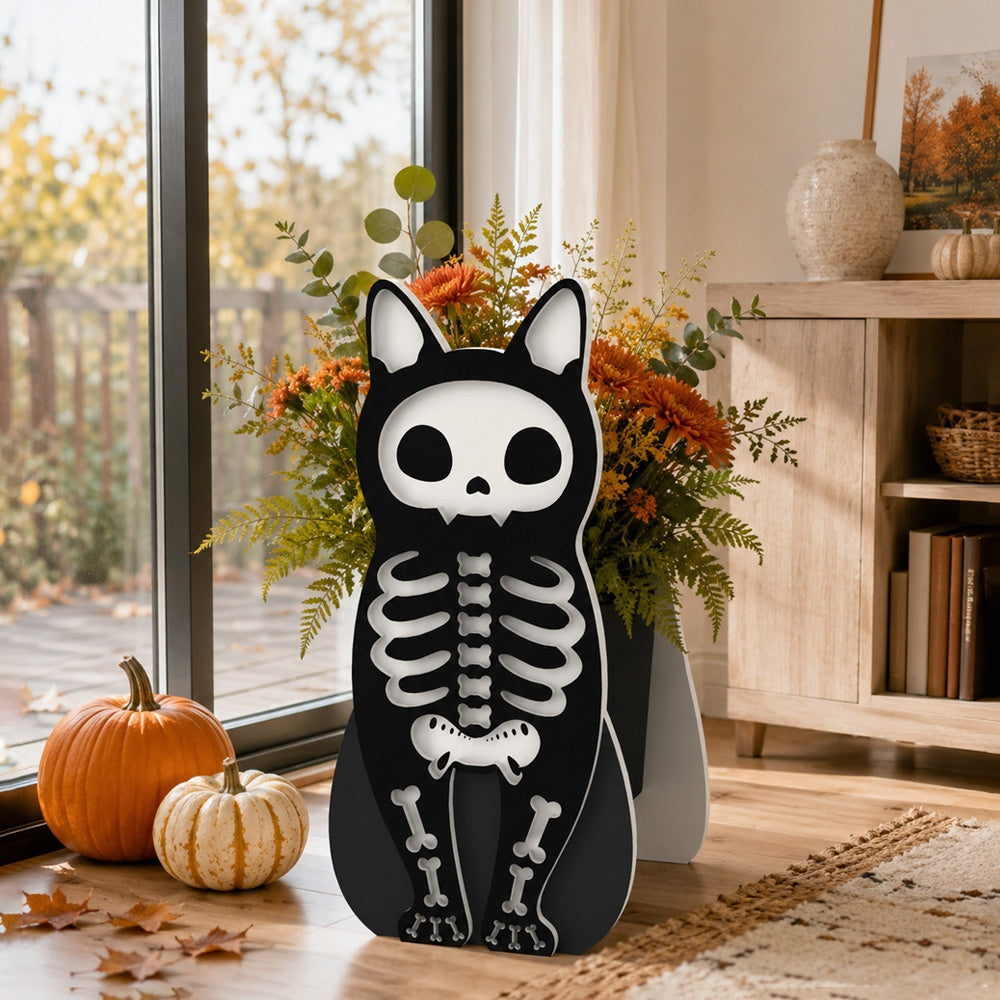 Halloween Skull Cat Planter filled with fresh flowers is placed in the garden