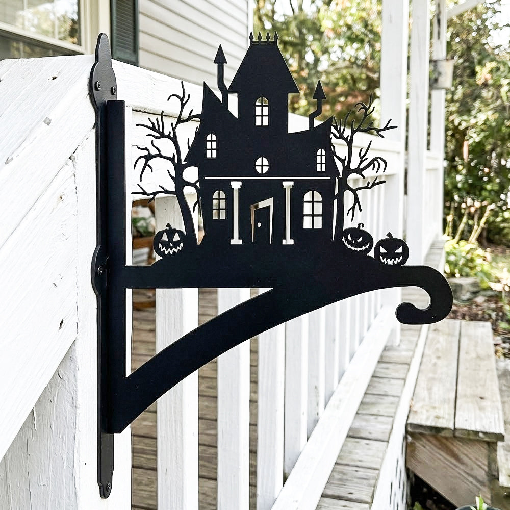 Haunted house metal hanging basket bracket mounted on outdoor wall for plant decoration