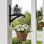 Haunted house metal hanging basket bracket mounted on outdoor wall for plant decoration