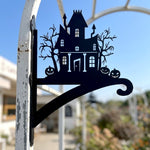 Haunted house metal hanging basket bracket mounted on outdoor wall for plant decoration