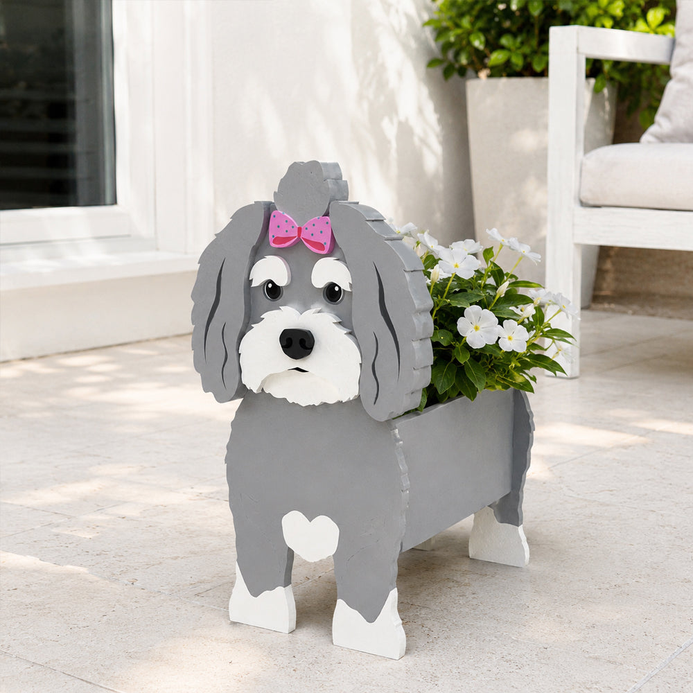 Havanese dog planter filled with fresh flowers is placed in the garden