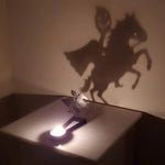 Headless horseman halloween metal candle holder casting a spooky shadow on the wall