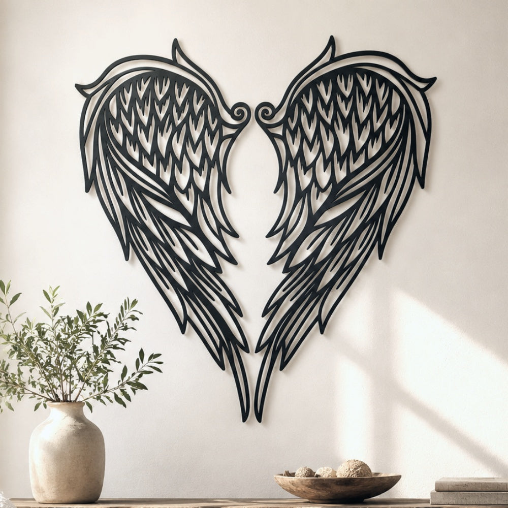 Black metal Heart Angel wings wall art with intricate cutout details displayed on the wall