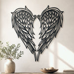 Black metal Heart Angel wings wall art with intricate cutout details displayed on the wall