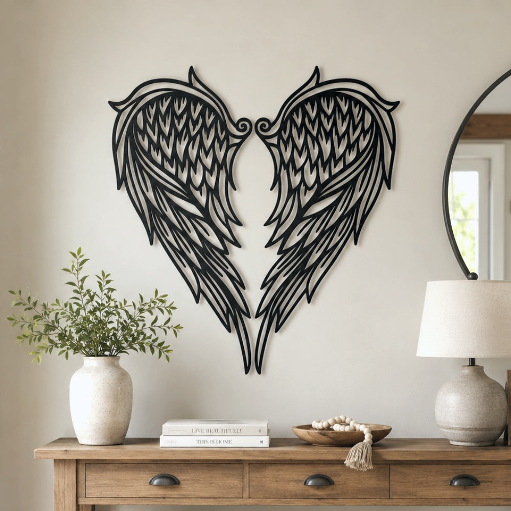 Black metal Heart Angel wings wall art with intricate cutout details displayed on the wall