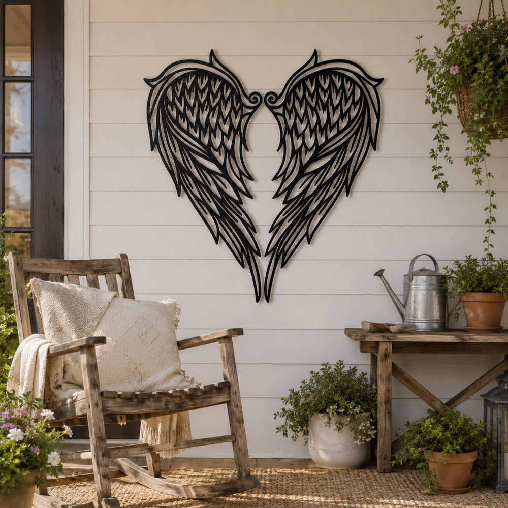 Black metal Heart Angel wings wall art with intricate cutout details displayed on the wall
