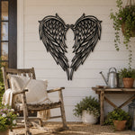 Black metal Heart Angel wings wall art with intricate cutout details displayed on the wall