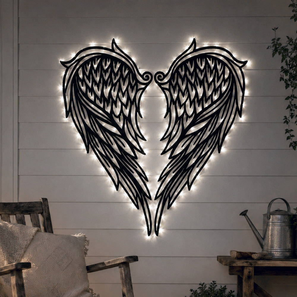 Black metal Heart Angel wings wall art with Soft White LED Lighting displayed on the wall