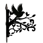 Hummingbird flying on branch metal hanging basket bracket mounted on outdoor wall for plant decoration