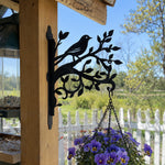 Hummingbird stand on branch metal hanging basket bracket mounted on outdoor wall for plant decoration