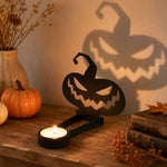 Jack-o’-Lantern halloween metal candle holder casting a spooky shadow on the wall