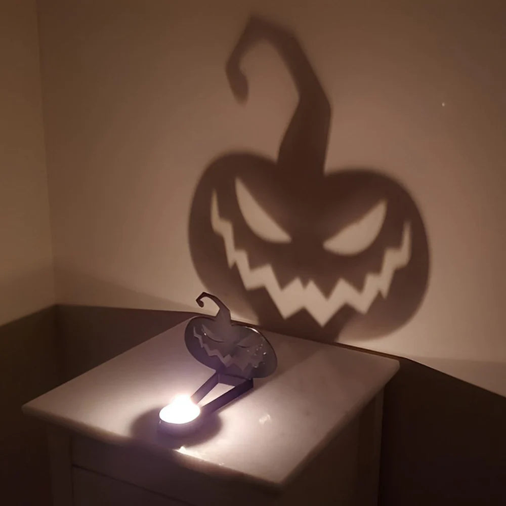 Jack-o’-Lantern halloween metal candle holder casting a spooky shadow on the wall