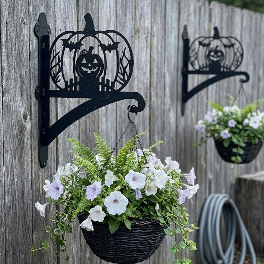 Jack-o’-lantern metal hanging basket bracket mounted on outdoor wall for plant decoration