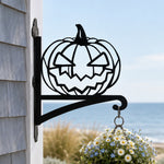 Jack-o’-lantern metal hanging basket bracket mounted on outdoor wall for plant decoration