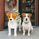 Jack Russell Terrier dog planter filled with fresh flowers is placed in front of the door