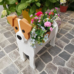 Jack Russell Terrier dog planter filled with fresh flowers is placed in the garden