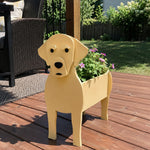 Labrador dog planter filled with fresh flowers is placed in the garden