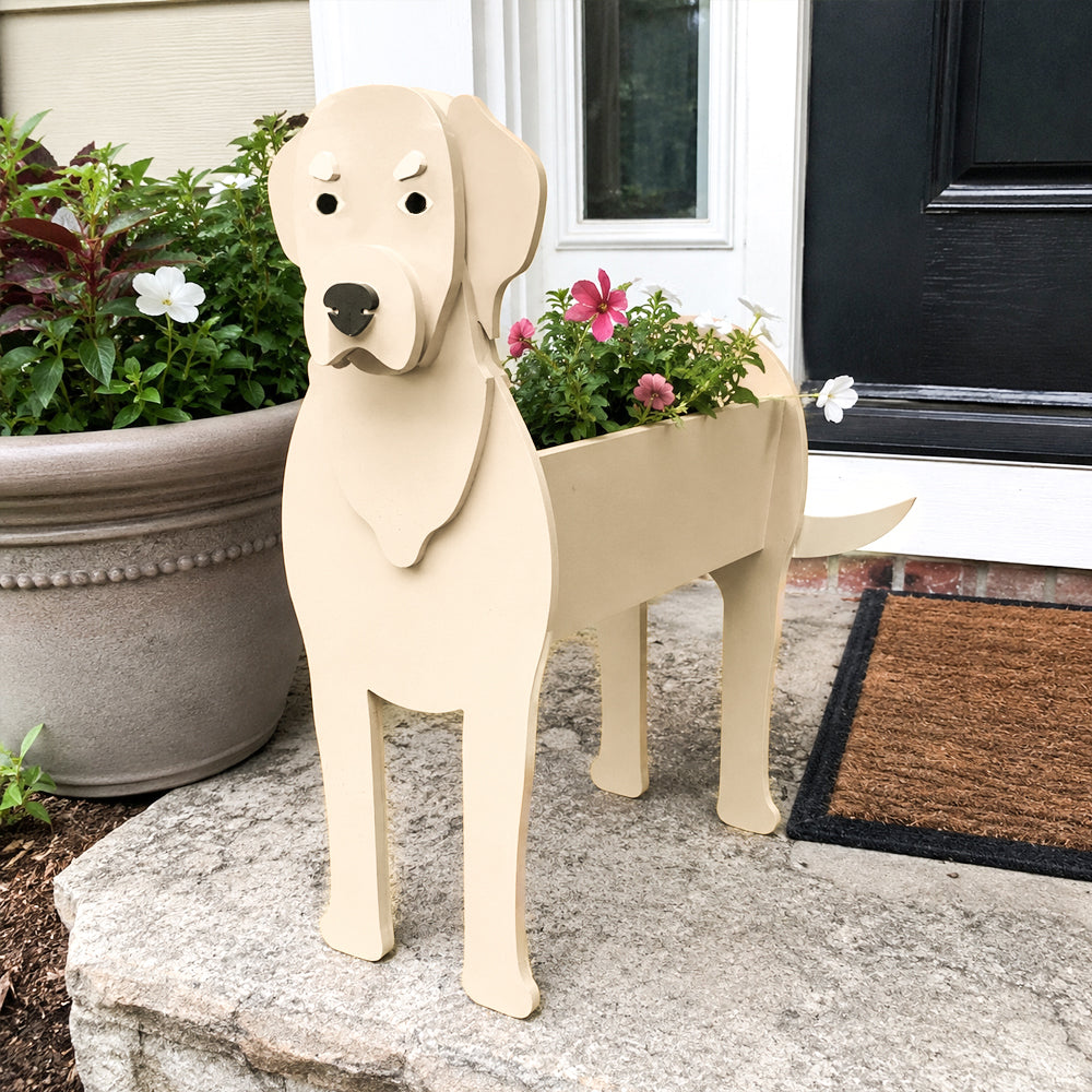 Labrador dog planter filled with fresh flowers is placed in the garden