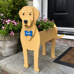 Labrador dog planter filled with fresh flowers is placed in the garden