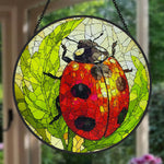 ladybug on green leaves stained glass suncatcher window hanging, suitable for home and garden decoration.