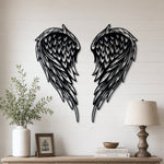 Black metal Layered Angel Wings wall art with intricate cutout details displayed on the wall