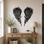 Black metal Layered Angel Wings wall art with intricate cutout details displayed on the wall