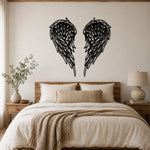 Black metal Layered Angel Wings wall art with intricate cutout details displayed on the wall