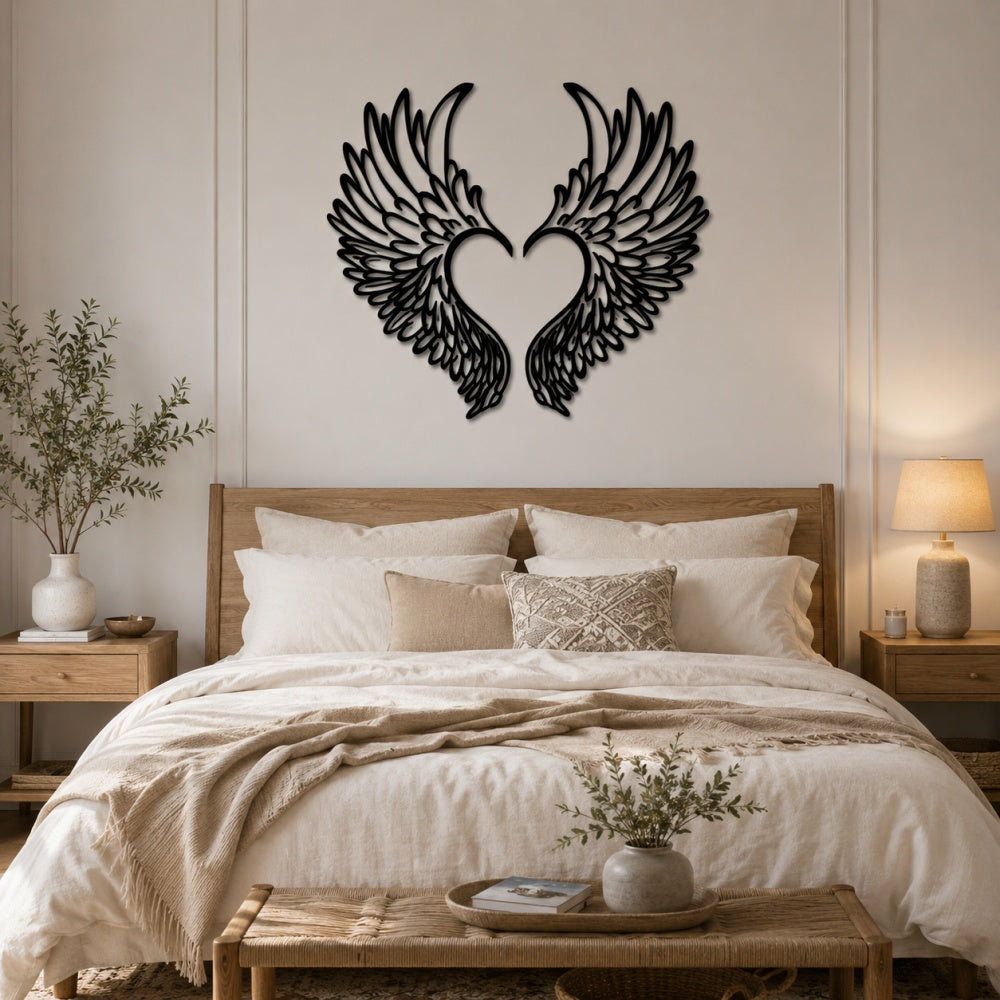 Black metal Love Angel wings wall art with intricate cutout details displayed on the wall
