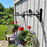 Love birds on branch metal hanging basket bracket mounted on outdoor wall for plant decoration