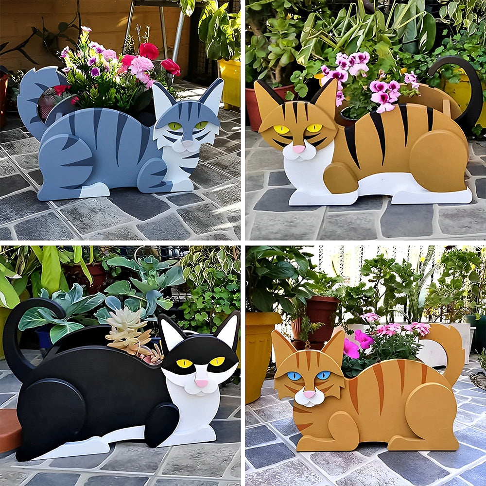 Lying cats planter filled with fresh flowers is placed in the garden