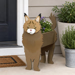 Maine Coon cat planter filled with fresh flowers is placed in the garden